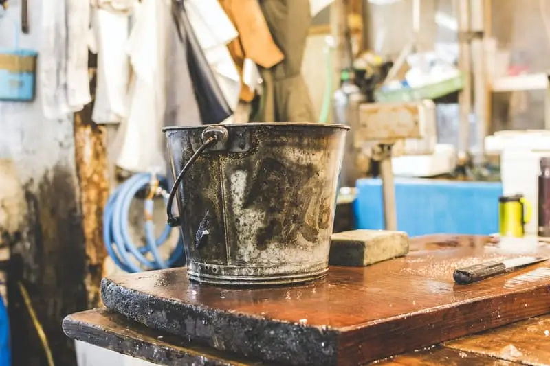 ash bucket next to a wood stove